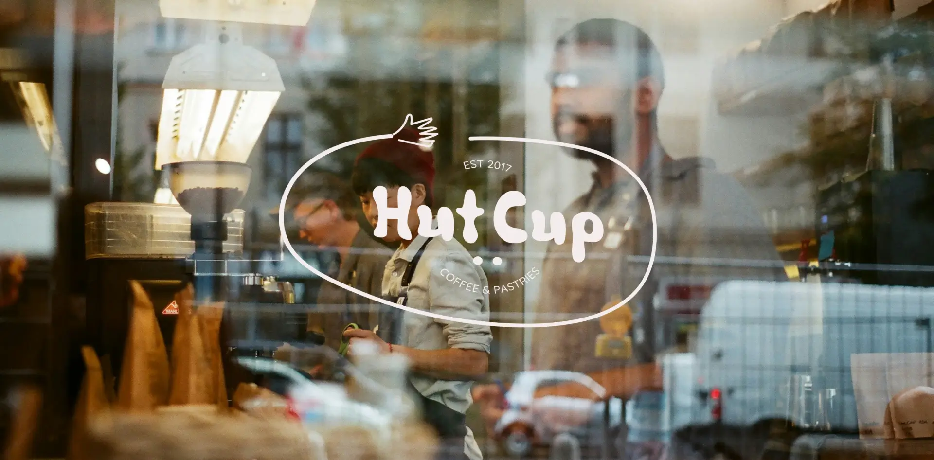 Coffee shop logo displayed on a window, showcasing professional branding services, brand identity design, and visual identity branding to attract customers with a modern, inviting aesthetic—perfect for cafes and coffee shops worldwide.